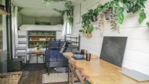 a room with a table and plants on the wall at Quirky Vintage Horsebox Truck in Balcombe