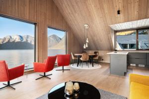 a living room with a table and chairs and a large window at Wangen Apartments in Aurland