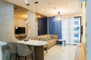 a living room with a white table and a couch at Apartment in Quận 10 - 1 Room Ha Do Centrosa in Ho Chi Minh City