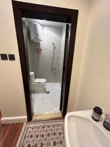a bathroom with a shower and a tub and a toilet at Secret Garden Studio استوديو بمدخل جانبي خاص ودخول ذكي in Riyadh