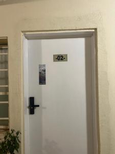 a white door with a sign on it at Secret Garden Studio استوديو بمدخل جانبي خاص ودخول ذكي in Riyadh