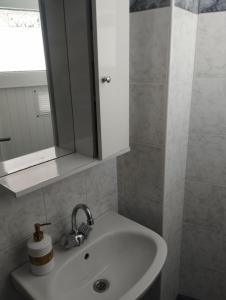 a white sink in a bathroom with a mirror at My Sisters House in Agios Nikolaos +53 photos