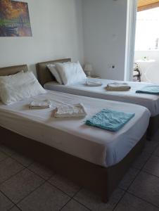 two beds sitting next to each other in a room at My Sisters House in Agios Nikolaos