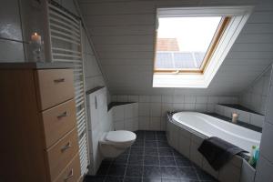 La salle de bains est pourvue d'une baignoire, de toilettes et d'une fenêtre. dans l'établissement Idylle im Fränkischen Seenland, à Meinheim
