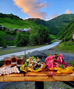 a table with food and two glasses of beer at Hotel Dauber in Lalkhori