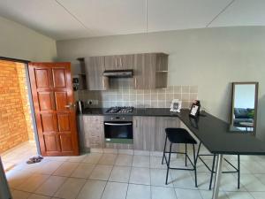 a kitchen with a counter and a table and chairs at Yanaz Place in Germiston