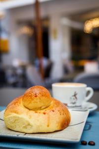 un prodotto da forno su un piatto accanto a una tazza di caffè di DOMUS LUIGI LEONE 2 a Napoli