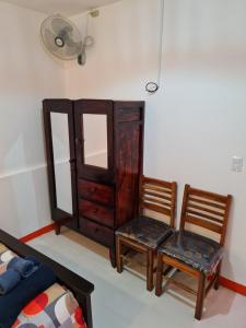 a bedroom with two chairs and a dresser and a bed at Casa Naranja in Granada