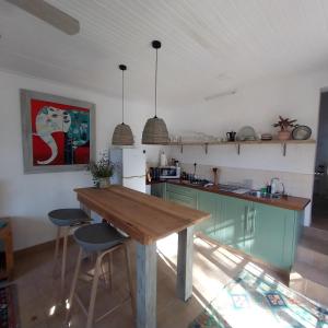 a kitchen with green cabinets and a wooden table at The Little Gem in Montagu