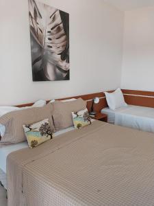 two beds sitting next to each other in a room at Leme Plaza Hotel in Leme