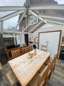 a dining room with a wooden table with bananas on it at Maypole Farm, Cawood in Selby +11 photos