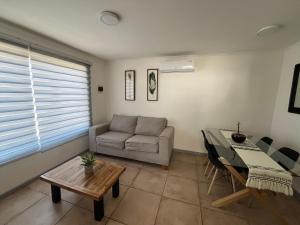 - un salon avec un canapé et une table dans l'établissement Casa en Villa Galilea, à Curicó