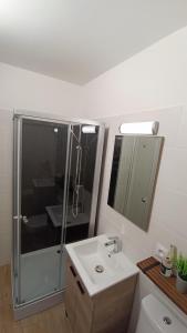 a bathroom with a shower and a sink at New Hôtel de la Mer in Fécamp