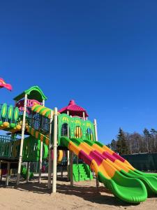 a playground with a colorful slide at a park at Bursztynowo Mikoszewo in Mikoszewo