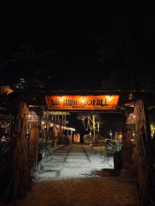 a building with a sign that reads oneillion coil iii at night at Na Thẩm Eco Hill Homestay - Trạm Tấu in Cham Ta Lao