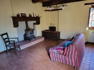a living room with a couch and a fireplace at bacciano casa vacanze in Poggio