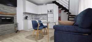 a living room with a table and a blue chair at Casa Cazorla c del valle II in Cazorla