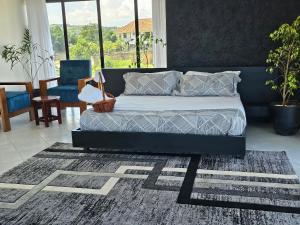 a bedroom with a bed and a rug at Muguet by Ibiscot development in Kampala