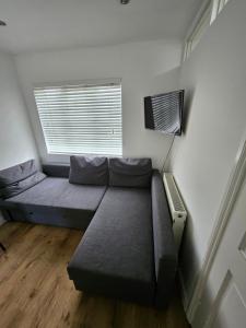 a bed in a room with a window at Nice and Cosy One Bed Flat in Carshalton