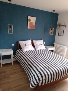 a bedroom with a large bed with two pillows at New Hôtel de la Mer in Fécamp