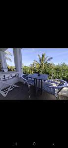 a patio with a table and chairs on a balcony at Tam Studio in La Gaulette