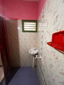 a small bathroom with a sink and a window at Sri Thirumal Home Stay in Kumbakonam