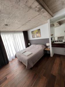 a bedroom with a bed and a mirror and a sink at Departamentos en Gral Paz a pasos de clínicas in Córdoba