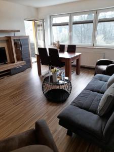 a living room with a couch and a table at BestBoarding24 in Schöllkrippen