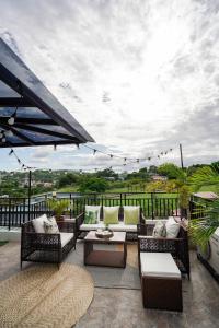 a patio with wicker chairs and tables on a balcony at JMO Apartments in Antipolo