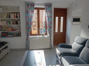 a living room with a couch and a window at "Chez la Joe" in Thélonne