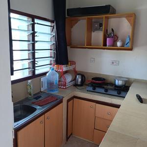 a kitchen with a sink and a counter top at Avril's studio apartment in Mombasa