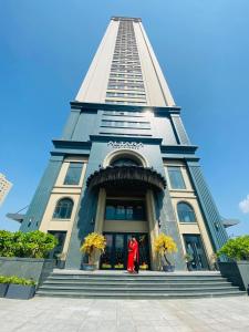 a tall building with a red dog in front of it at Luxury Apartment Altara in Quy Nhon
