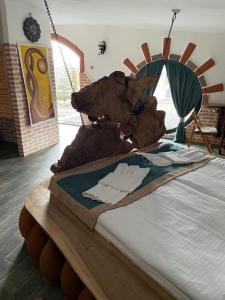 a bed in a room with a wooden head board at ART Chalet in Akhaltsikhe