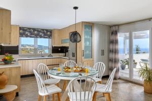 a kitchen and dining room with a table and chairs at Breathtaking sea view flat for families in Crete in Keratokampos