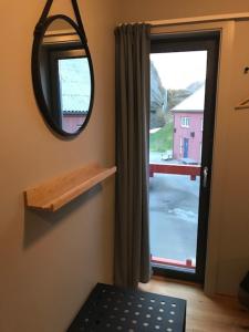 a room with a mirror and a door with a window at Verftet i Ny-Hellesund in Søgne