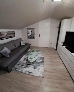 a living room with a couch and a coffee table at Royal Apartments Sandra in Štinjan