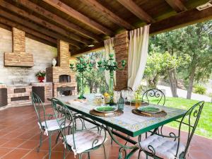 a table and chairs on a patio with a fireplace at Villa Nunziatina in Carlentini