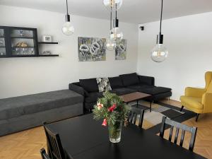 a living room with a black table and a couch at Apartmán Štefánik in Poprad
