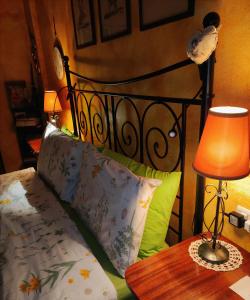a bedroom with a bed and a table with a lamp at B&B Le Fate Del Lago in Lierna