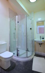 a bathroom with a shower and a toilet and a sink at North Lake District rural retreat in Penrith +13 photos