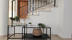 a table with plants on it next to a staircase at STAY Tranquility Cove in Larnaca