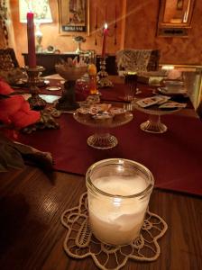 a table with a candle in a glass bowl on a table at B&B Le Fate Del Lago in Lierna