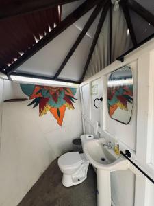 a small bathroom with a toilet and a sink at Machete WING SURF KITE & FOIL in Punta Chame