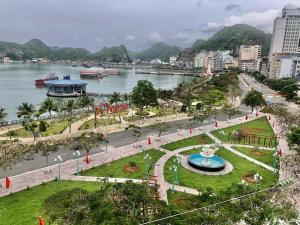 a view of a park next to a body of water at Lang Chai Hotel - Travel Agency in Cat Ba