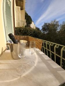 two wine glasses sitting on a table on a balcony at La Piastronata in Massa
