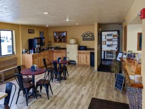 a kitchen with tables and chairs and a refrigerator at Gettysburg Inn and Suites in Gettysburg