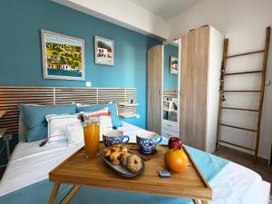 a table with a tray of food on a bed at Casa Portokali Chalkidiki - Modern Comfort with Authentic Greek Charm in Nea Potidaea