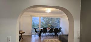 a dining room with a table and chairs and a window at Wohnung im Schwarzwald mit Panorama Blick in Kleines Wiesental