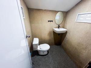 a bathroom with a toilet and a sink and a mirror at Soukaina Beach Bungalow in Ko Phangan