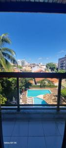 una finestra con vista sulla piscina di Apartamento 3 quartos Cabo Frio Praia do Forte a Cabo Frio
